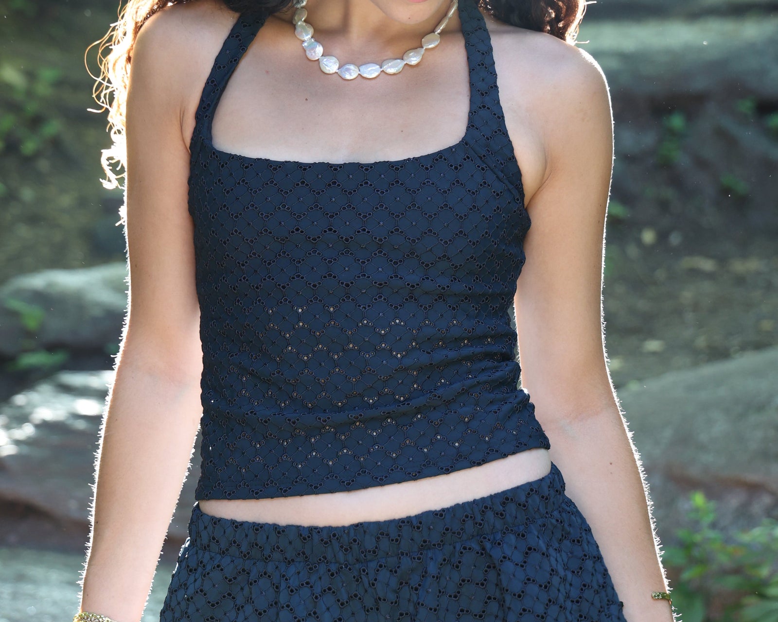 Model wearing the Eyelet Tzofia Halter Swim Top, featuring a supportive fit, elegant full coverage, and lightweight fabric designed for confident, family-friendly swimwear.
